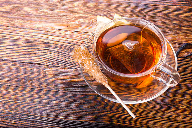 istock cup of tea with lemon on wooden background 470920444