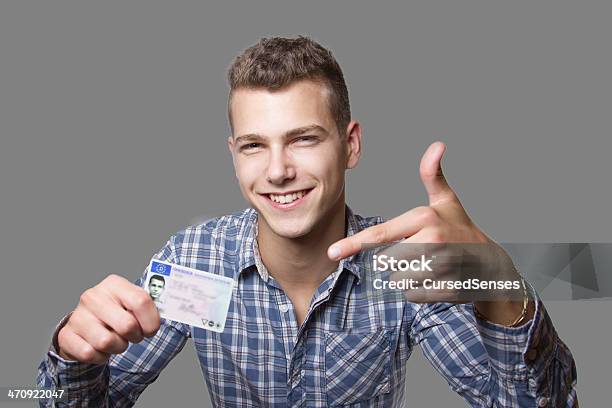 Young Man Showing Off His Driver License Stock Photo - Download Image Now - Driver's License, Identity, Holding