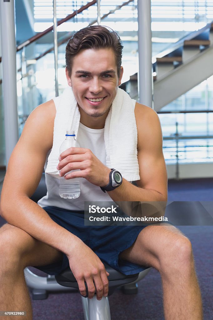 Fit man taking a break from working out Fit man taking a break from working out at the gym 20-24 Years Stock Photo