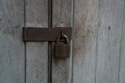 Woman's hand unlocking house door with key