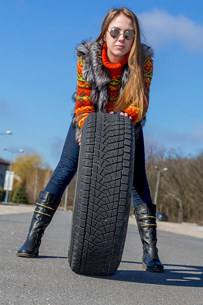 istock Female biker rolls big wheel 470926462