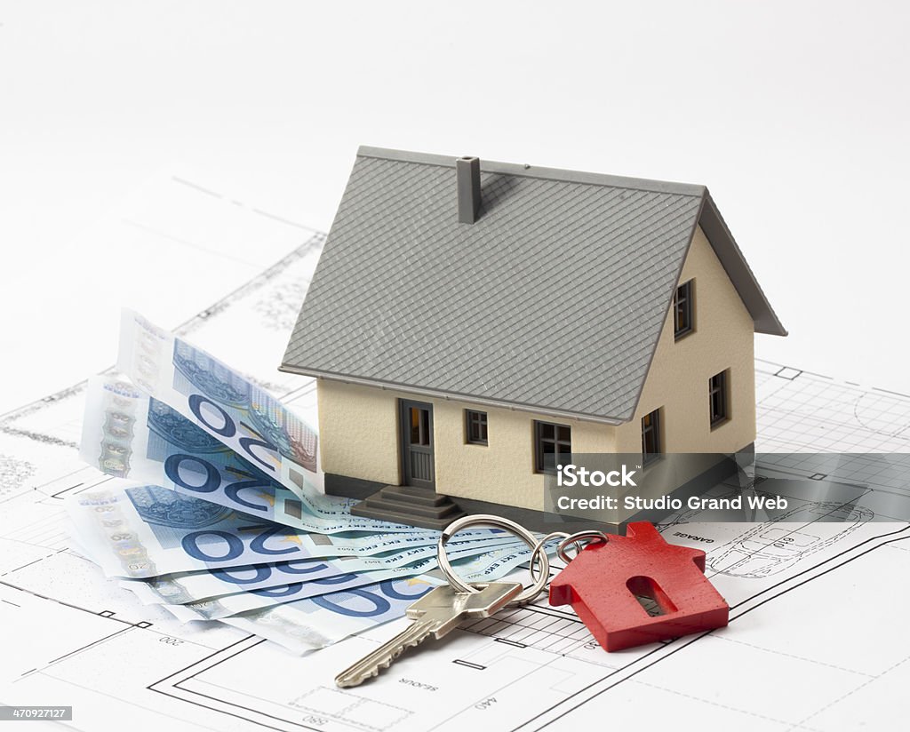 getting a loan for a new home ownerhsip spending money to acquire an architect house with personalised blueprint Architect Stock Photo