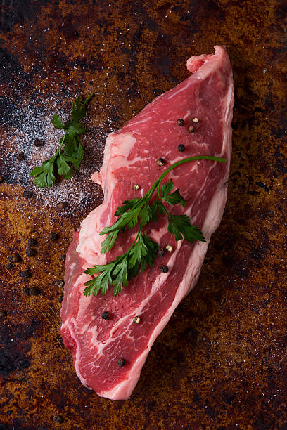 istock Raw steak top view with parsley leaves 470927844