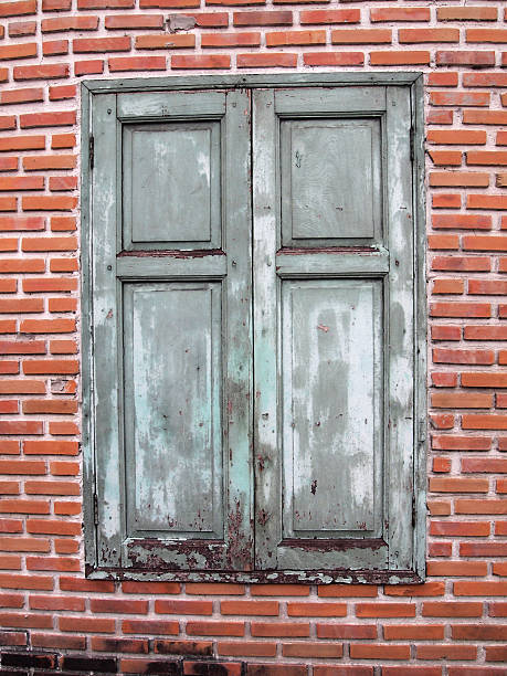 istock Brown wooden window on brick wall 470927891