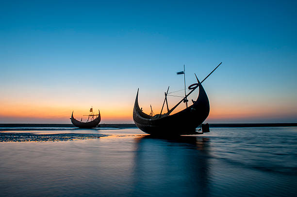 The silhouette of fishing boat on beach, Bangladesh In local language, the boat is called Pansi. It is built in a very beautiful and elegant way to fight with the open water of Bengal bay. bangladesh photos stock pictures, royalty-free photos & images