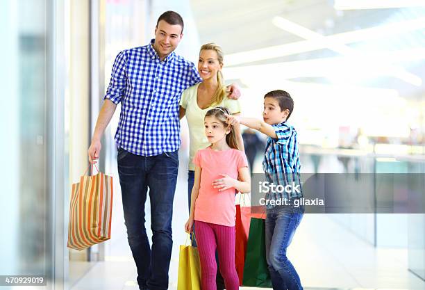 Smiling Family Shopping Together Stock Photo - Download Image Now - 30-39 Years, Adult, Blue