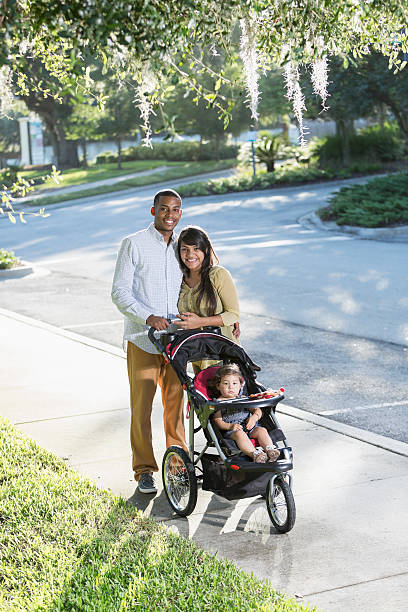 istock Young family with baby in stroller 470931001
