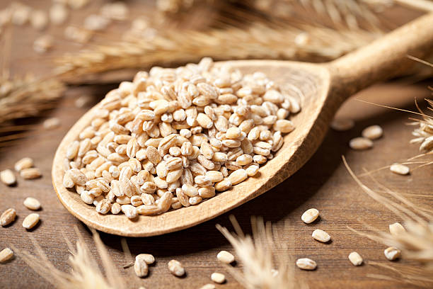 istock Wheat seed in spoon on old wooden table 470931668