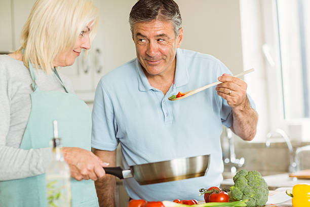 istock Happy mature couple making dinner together 470932864