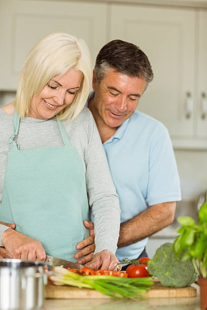 istock Happy mature couple making dinner together 470932874