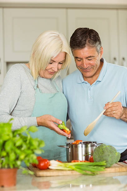 istock Happy mature couple making dinner together 470932900