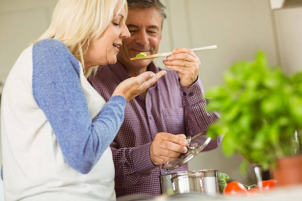 istock Mature couple preparing meal together 470933352