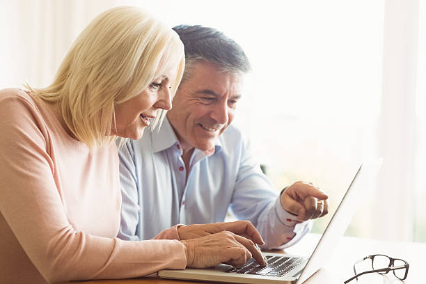 istock Happy mature couple using laptop 470933804