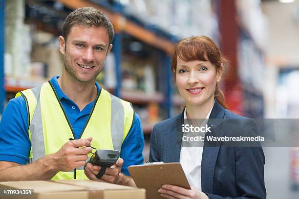 Arbeiter Und Manager Im Warehouse Scannenpackage Stockfoto und mehr Bilder von 2015 - 2015, 30-34 Jahre, Arbeiten