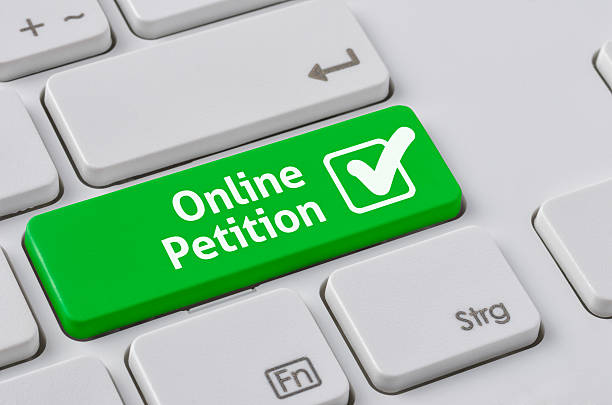 Keyboard with a green button - Online Petition stock photo