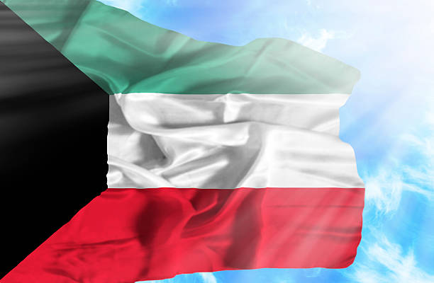 istock Kuwait waving flag against blue sky with sunrays 470934545
