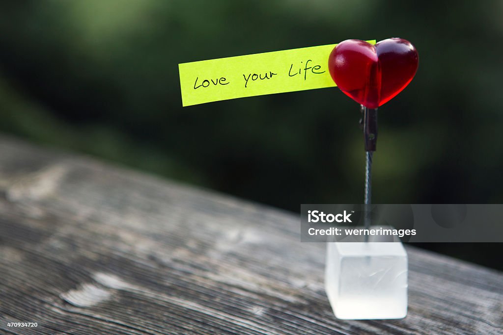 handwritten quote: "love your life" handwritten quote "love your life" on paper clipped on a heart Fun Stock Photo