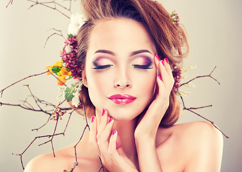 	Girl with delicate flowers in hair and fashion fuchsia nail