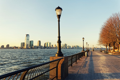 View of the Hudson River and the skyline of Jersey City from the walkway in Battery Park located in Lower Manhattan, New York City. 