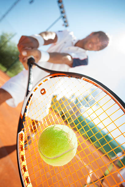 istock man with tennis racquet 470935419