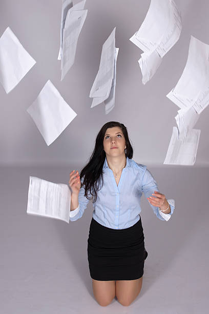 istock Woman throws out paper into the air 470936155
