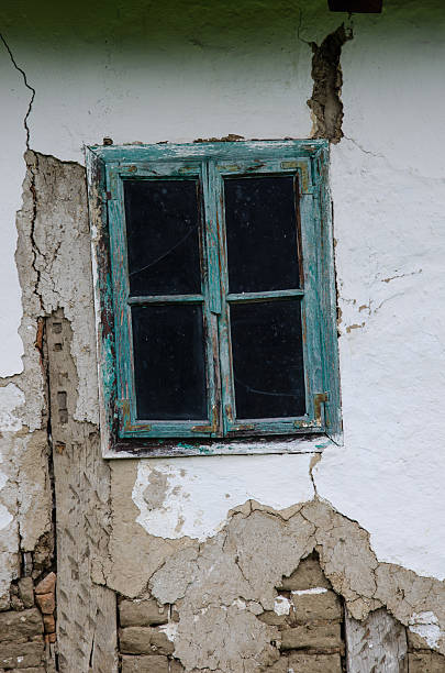 istock Turquoise blue old window on the old house of mud 470937902