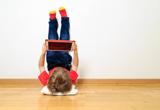 little boy looking at almohadilla táctil - playing playful baby contemporary fotografías e imágenes de stock