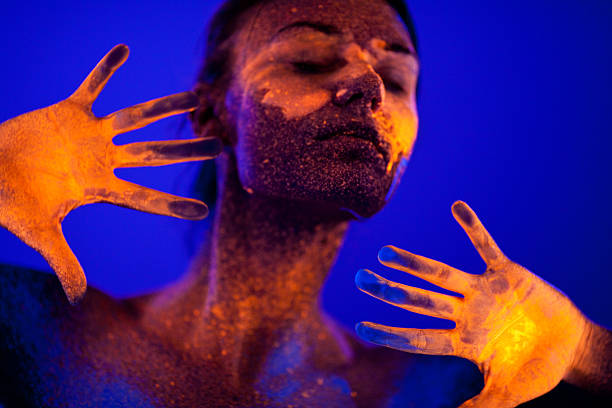 istock Portrait painted with fluorescent makeup under the ultraviolet l 470939738