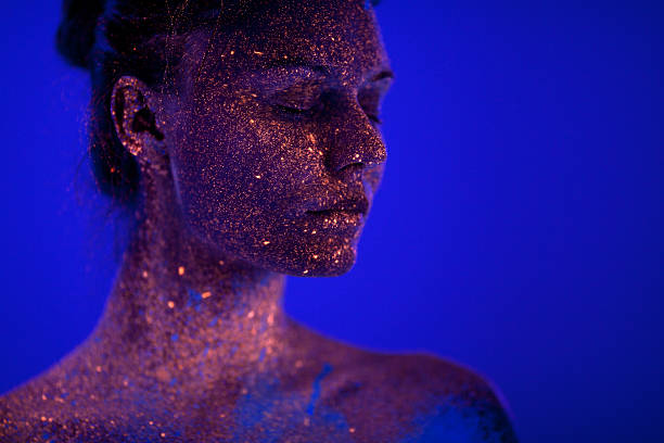 istock Portrait painted with fluorescent makeup under the ultraviolet l 470939746