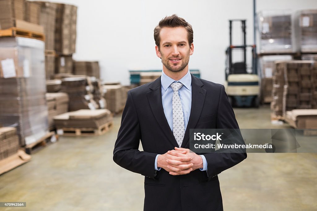 Warehouse manager standing hands together Warehouse manager standing hands together in the large warehouse 20-29 Years Stock Photo