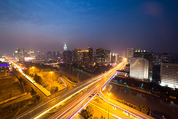 istock traffic light trails on overpass and cityscape at night 470942718