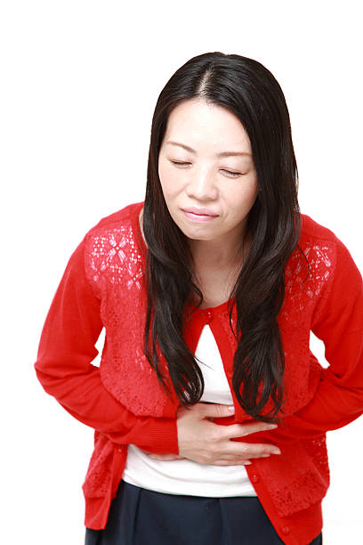 istock Japanese woman suffers from stomachache 470943370