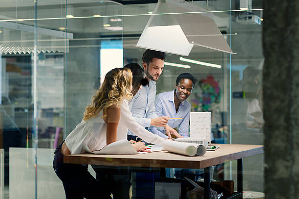 istock Multiethnic Team of architects reviewing architectural model in the office. 470944398