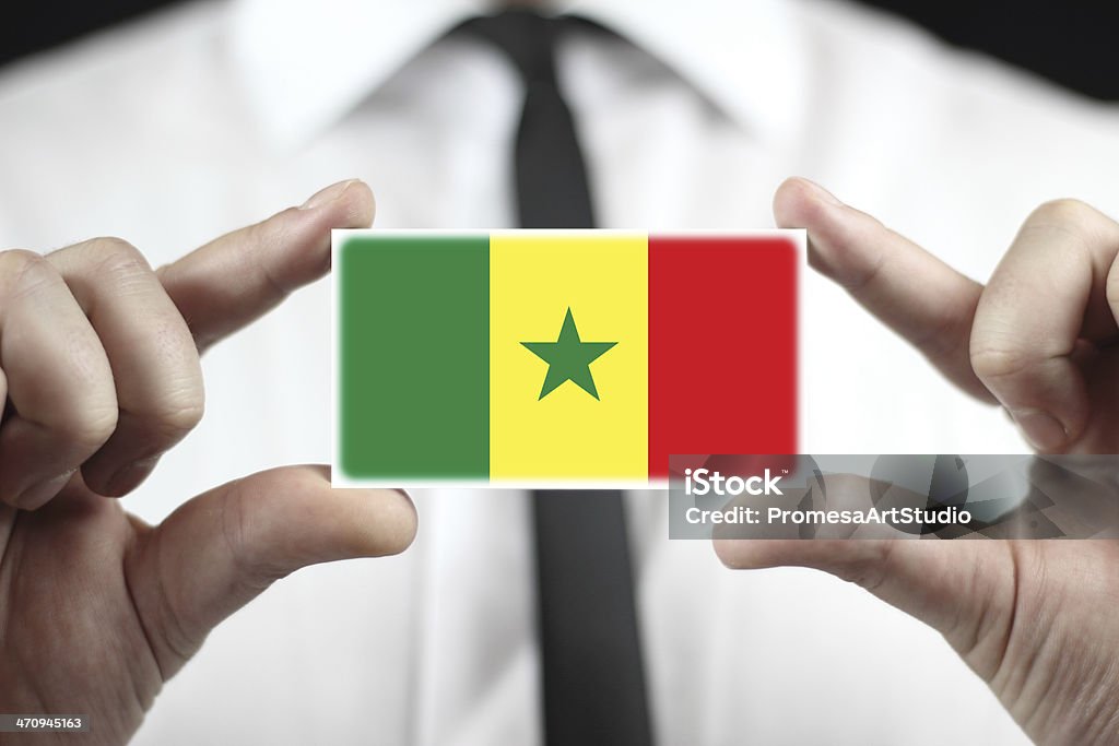 Businessman holding a business card with Senegal Flag Adult Stock Photo