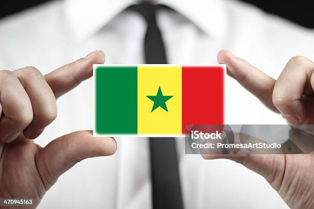 Businessman Holding A Business Card With Senegal Flag Stock Photo - Download Image Now