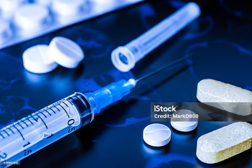 X-ray examination, syringe for injection, a vitamins and pills X-ray examination, syringe for injection, a vitamins and pills for treatment of disease. In blue tones 2015 Stock Photo