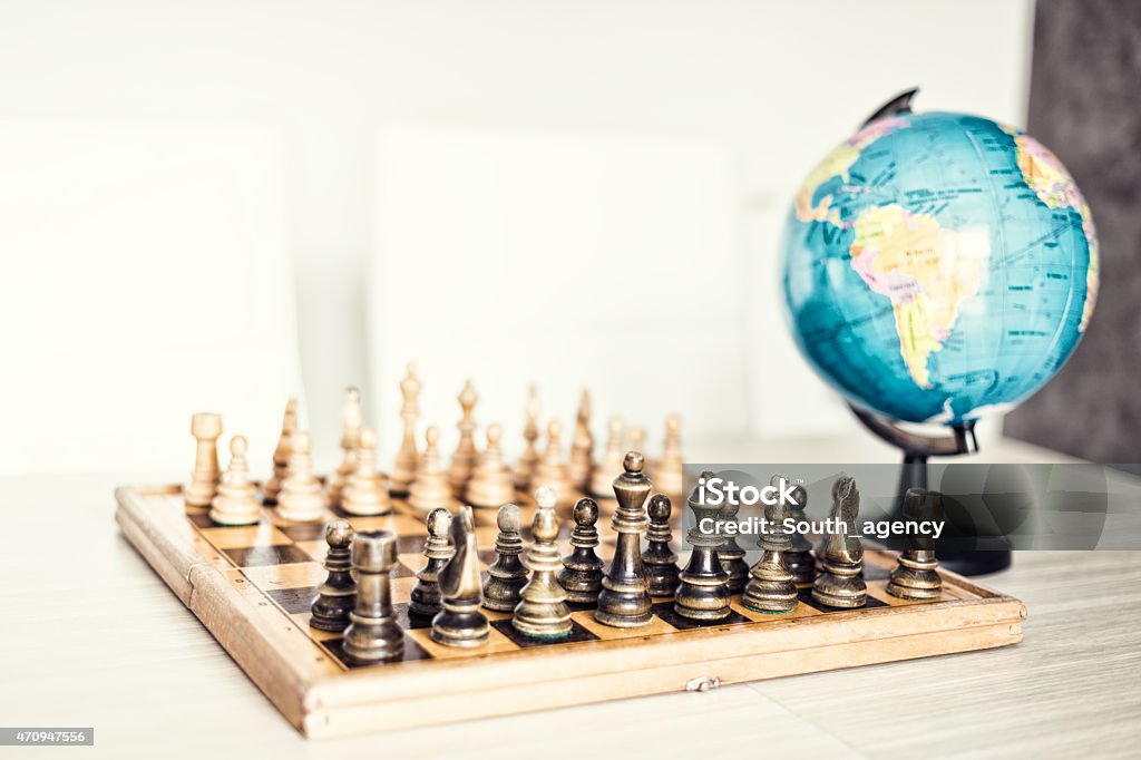 Risky move Risky move, chess and  globe 2015 Stock Photo