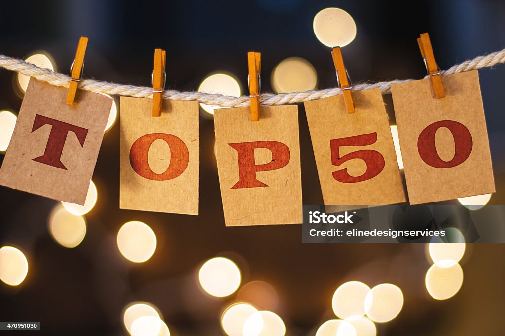 Top 50 Concept Clipped Cards and Lights The words TOP 50 printed on clothespin clipped cards in front of defocused glowing lights. 2015 Stock Photo
