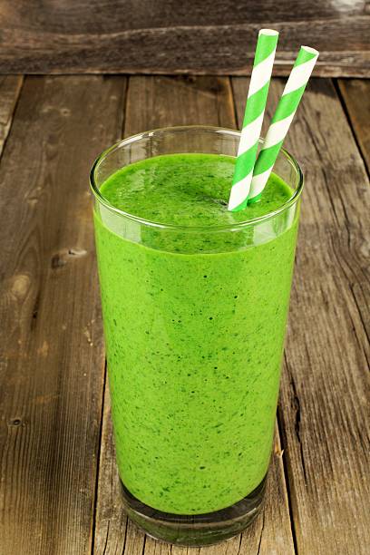 istock Green smoothie on a rustic wood background 470955130