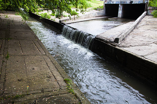 istock Water stream flowing out the underground tunnel 470958498