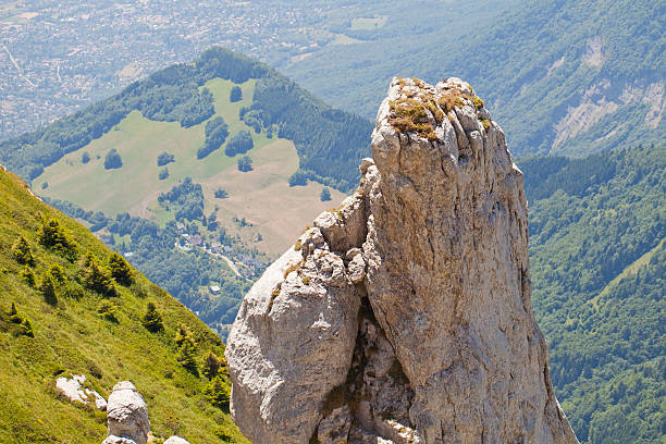 Isere Valley and calcareous needle. Calcareous rock needle waiting for a climber.  isere river stock pictures, royalty-free photos & images