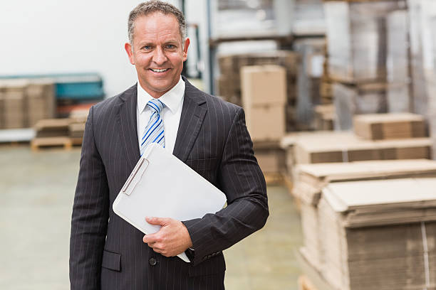 istock Portrait of a smiling boss holding clipboard 470958640