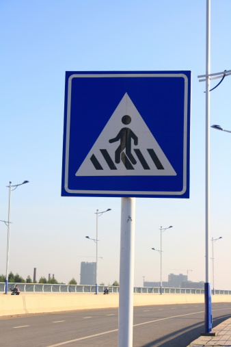 pedestrian crossing traffic sign over blue sky
