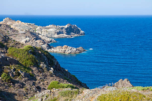Cap des Salt de Sa Nau in Cap de Creus, Costa Brava landmark in Catalonia, Deep blue sea and geological dikes in metamorphic structures in the land.