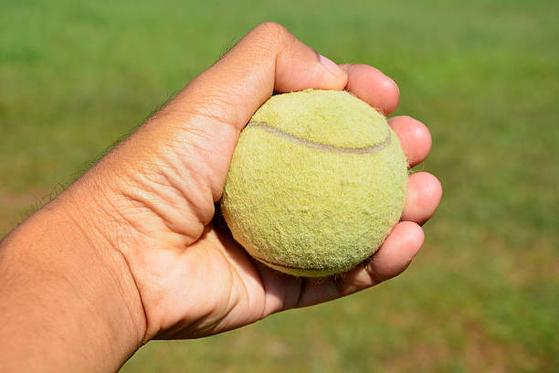 istock tennis ball in human hands 470963558