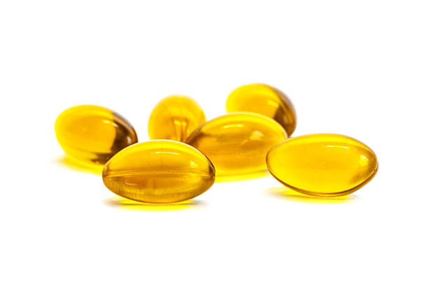 istock Fish oil supplement product capsules isolated on white 470963624