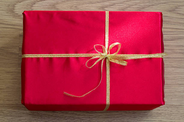 close-up of red gift. - bow christmas ribbon red стоковые фото и изображения