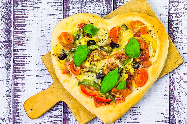 istock pizza shape heart wooden background 470964511