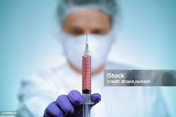 Doctor Holding Syringe Stock Photo - Download Image Now - Anesthetic, Vaccination, Male Nurse