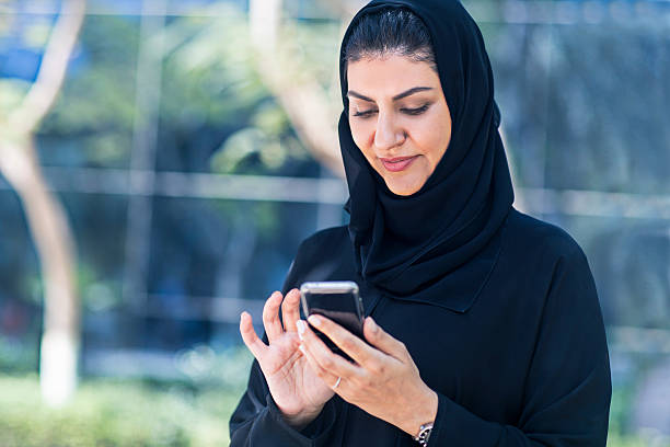 istock Arab Emirati woman sending a text messgaeportrait 470970294